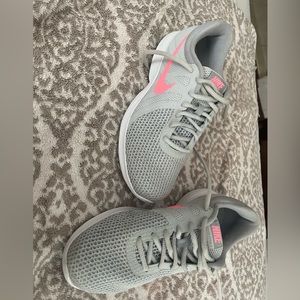 Women’s Nike Revolution 4 pink and grey sneakers